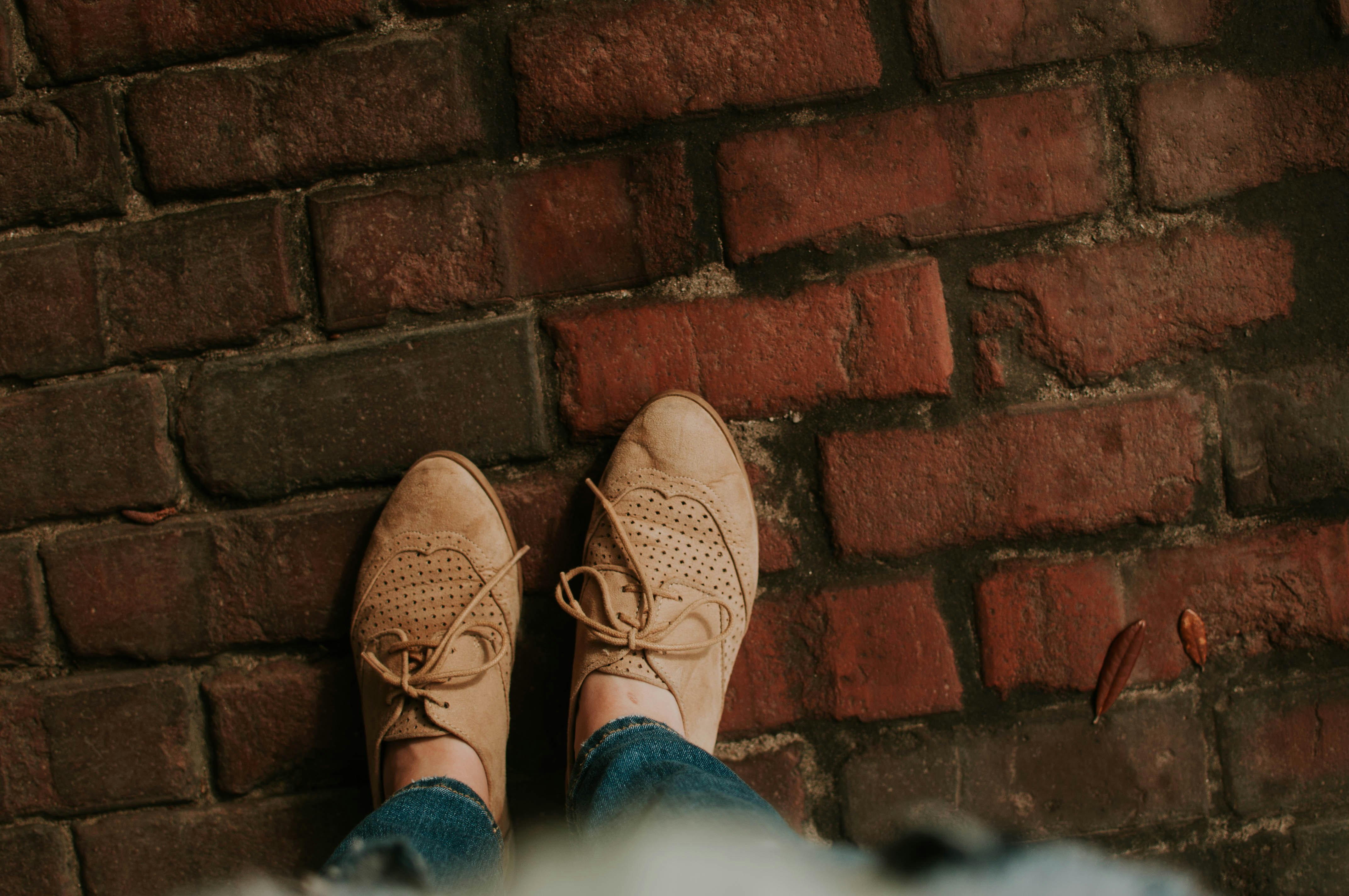 person standing on brick pavement